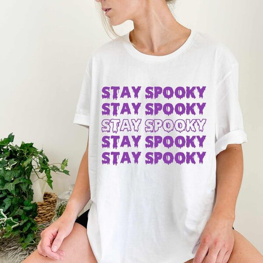 white tee with stay spooky in purple dripping letters